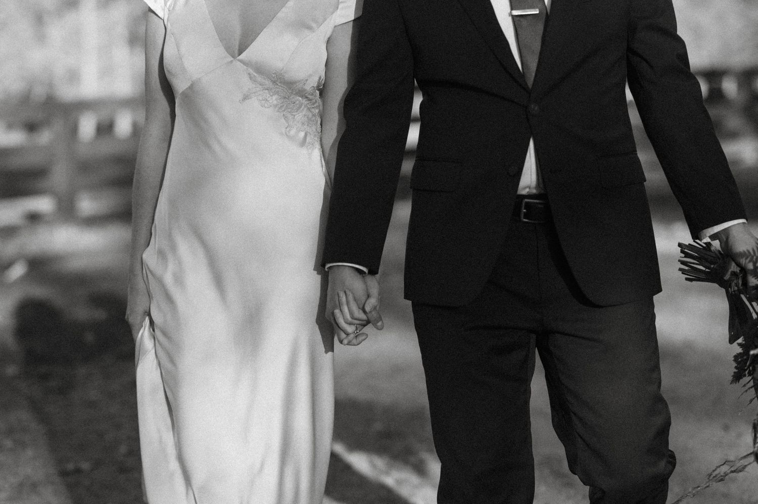 bride and groom holding hands