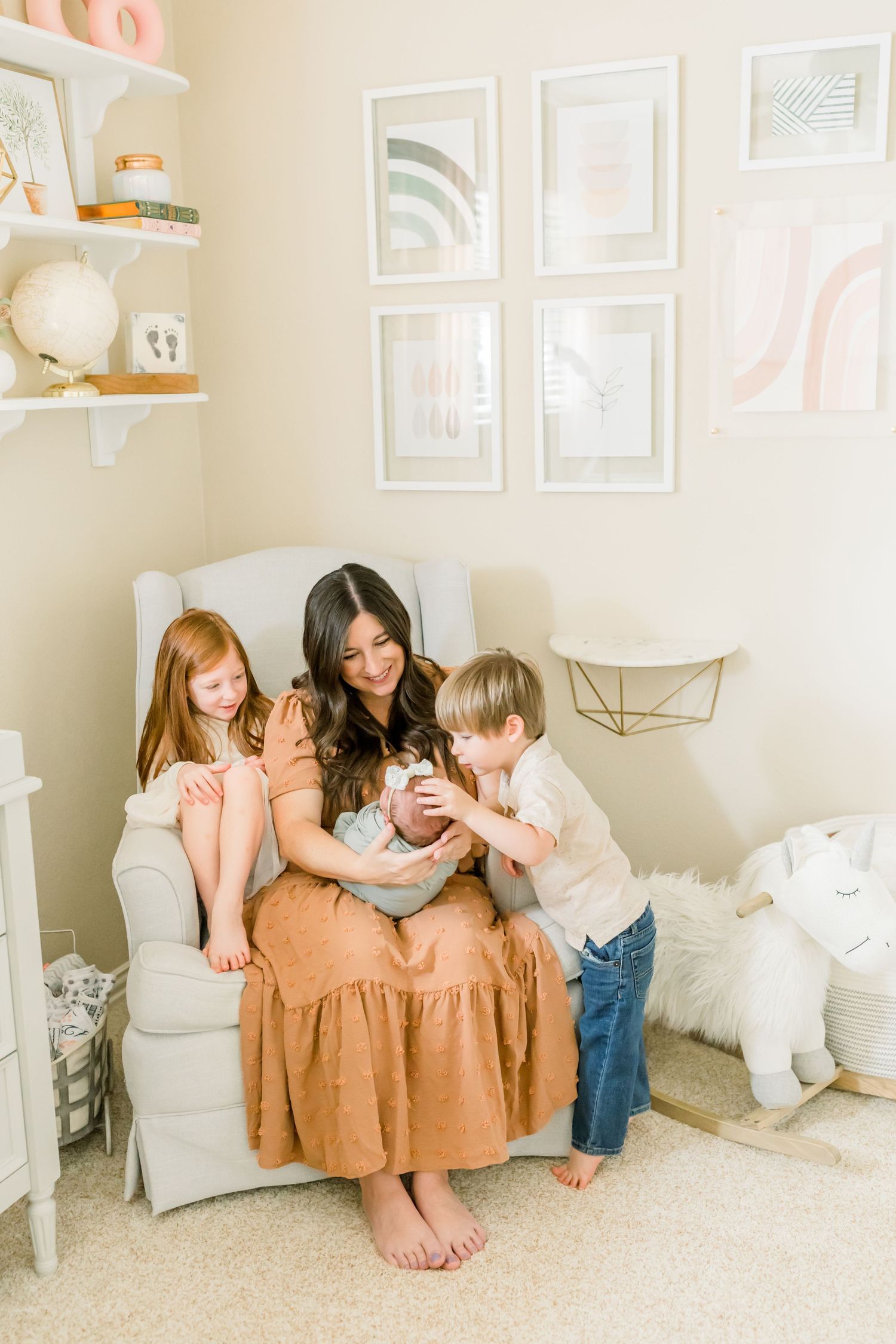 Heartwarming family scene in a beautifully decorated nursery with modern wall art and shelving.