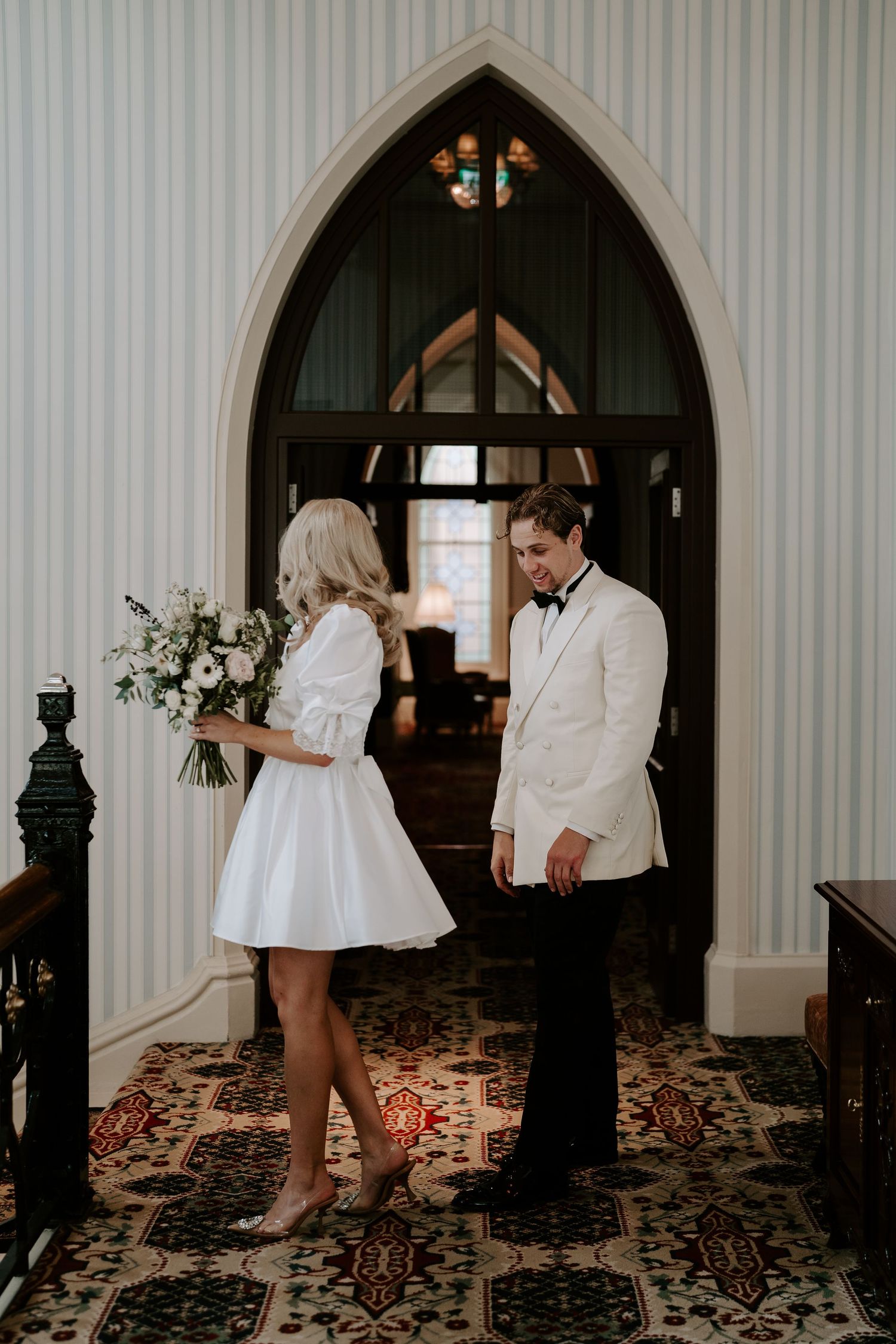 bride showing groom her dress at the Randolph hotel in oxford