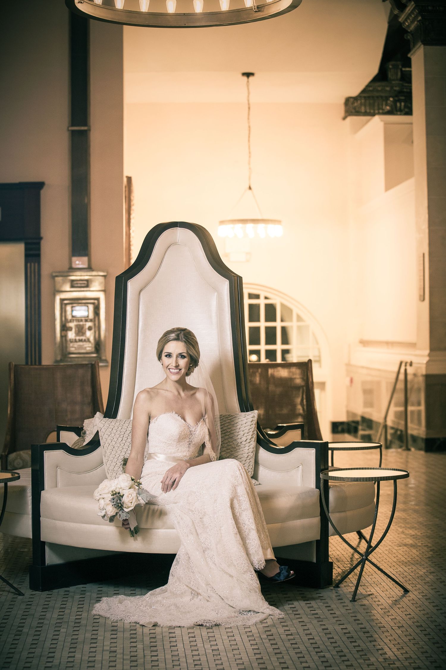 Vintage-style wedding portraits taken in an elegant room with classic furniture and soft lighting.