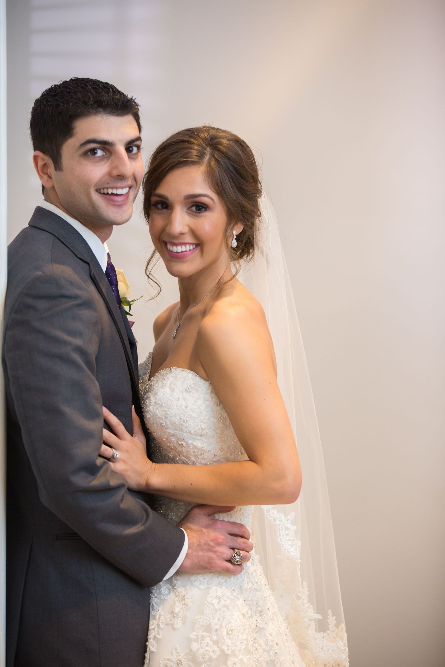 Elegant wedding portrait series showing couple in formal attire against light background.