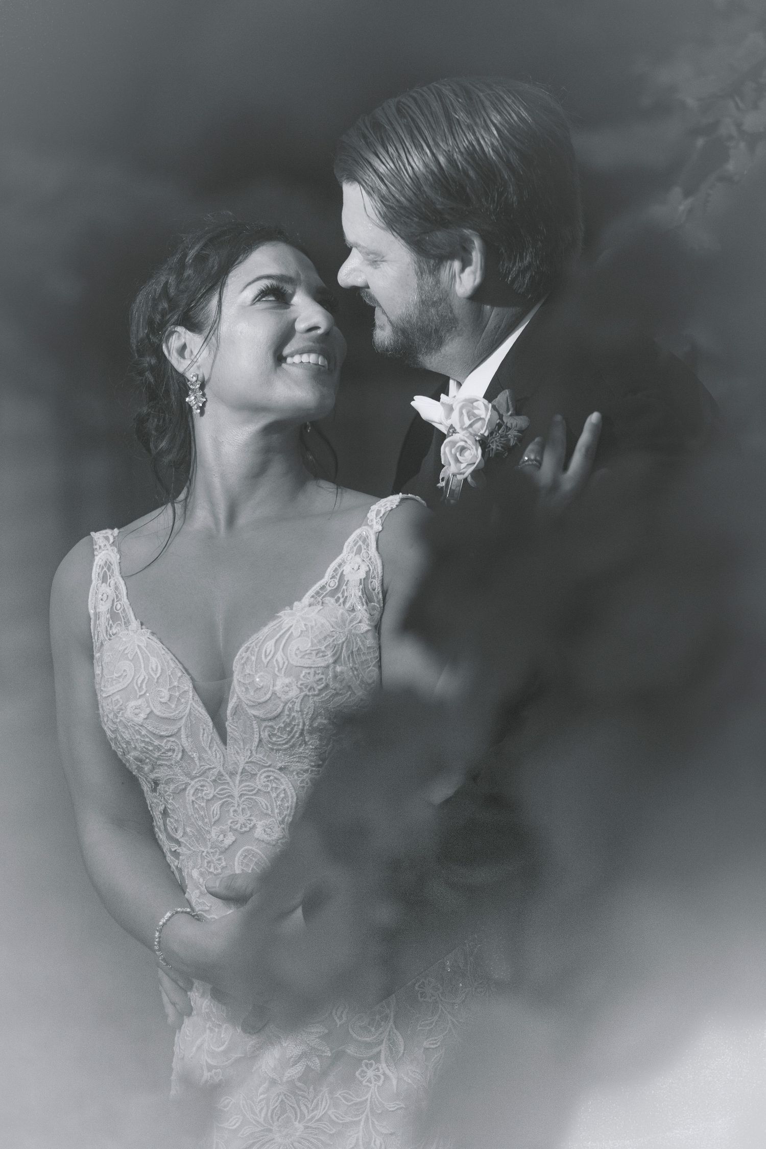 Romantic black and white wedding portraits captured in soft, dreamy lighting.