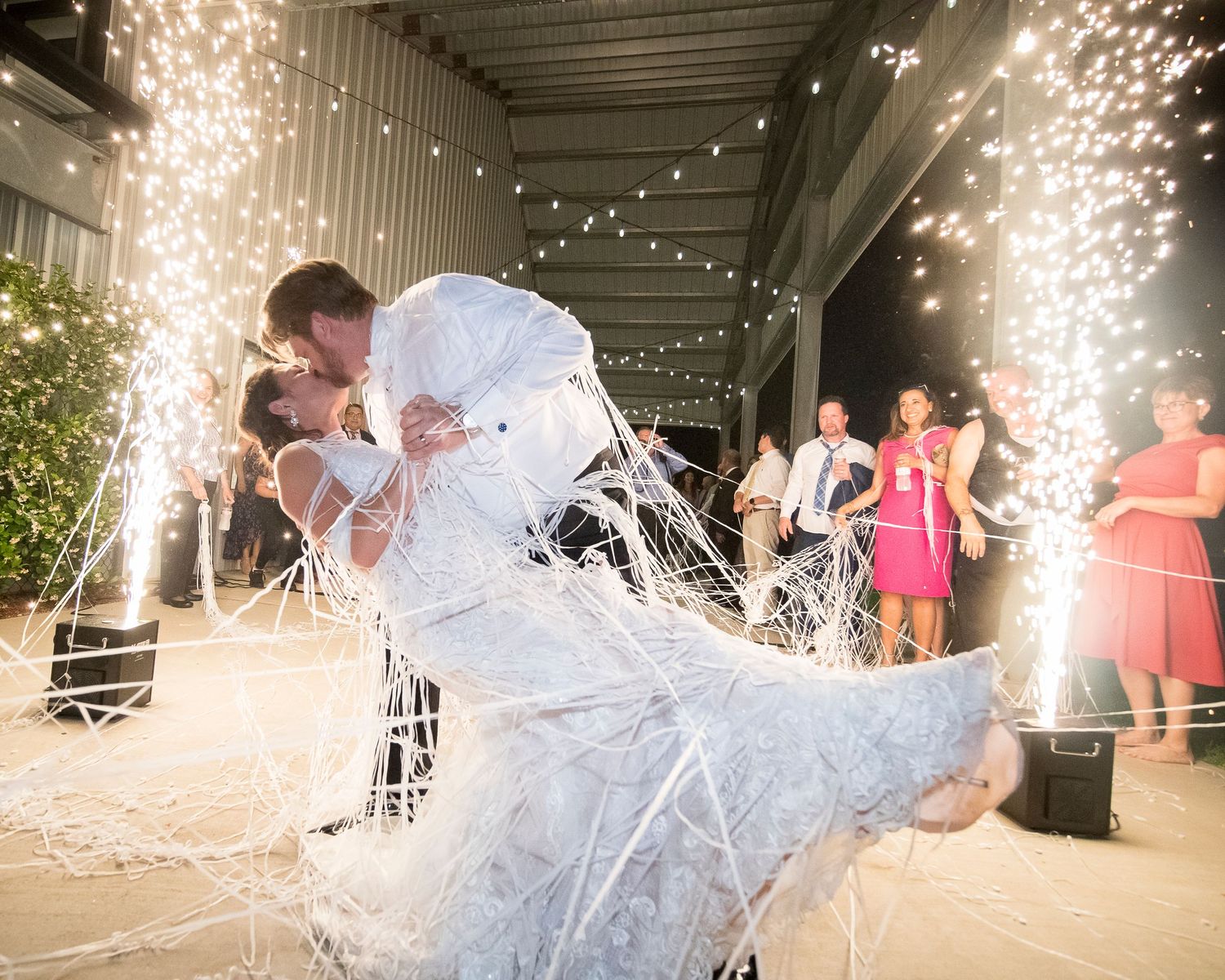Wedding celebration with sparklers creating magical light trails during evening reception.