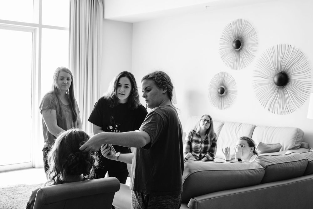 Black and white photo of bridal party getting ready together.