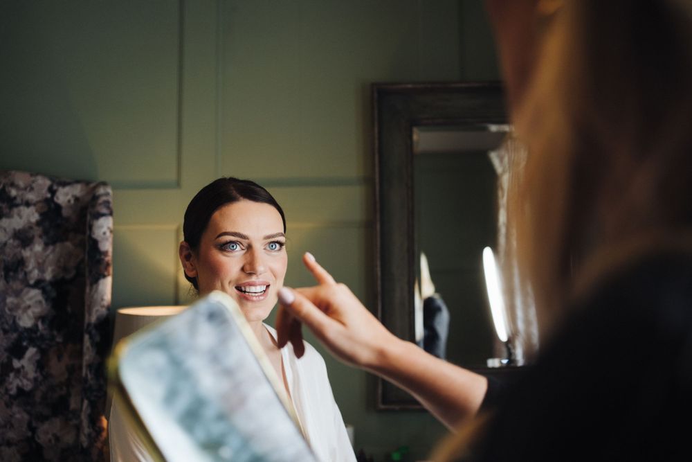 Getting ready scene with makeup application before wedding ceremony.