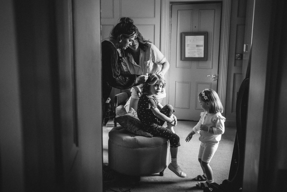 Black and white image showing tender family moment indoors.