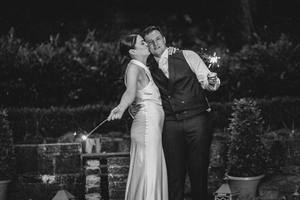 Romantic black and white portrait of a couple sharing a moment outdoors during their wedding.