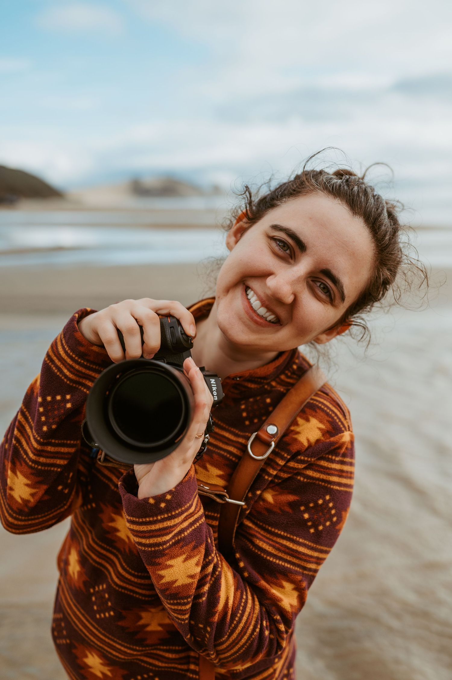 Photographer with camera enjoying a sunny day at the beach.