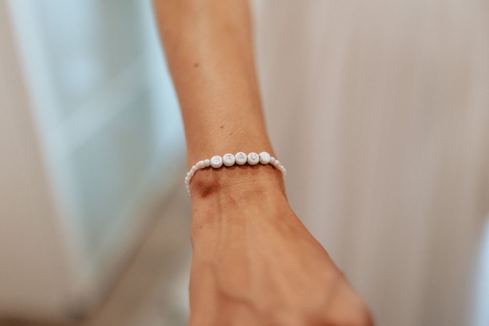 A delicate pearl bracelet worn on a wrist as wedding jewelry.