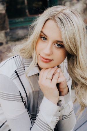 Closeup portrait of a woman wearing a plaid winter coat.