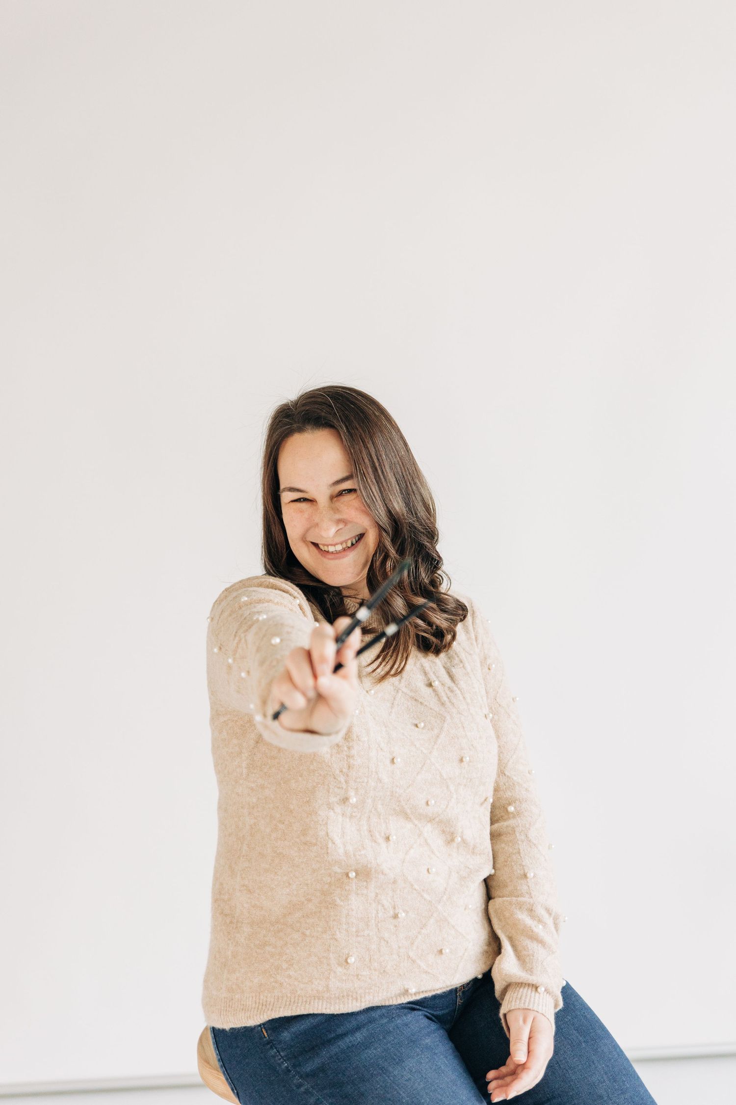 Charlotte branding photography for local artist holding paint brushes