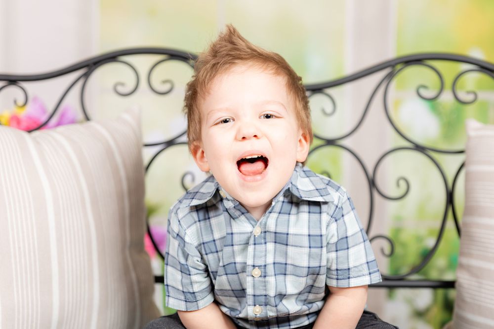 young child making silly face during spring mini session in studio in clayton new jersey Gloucester county