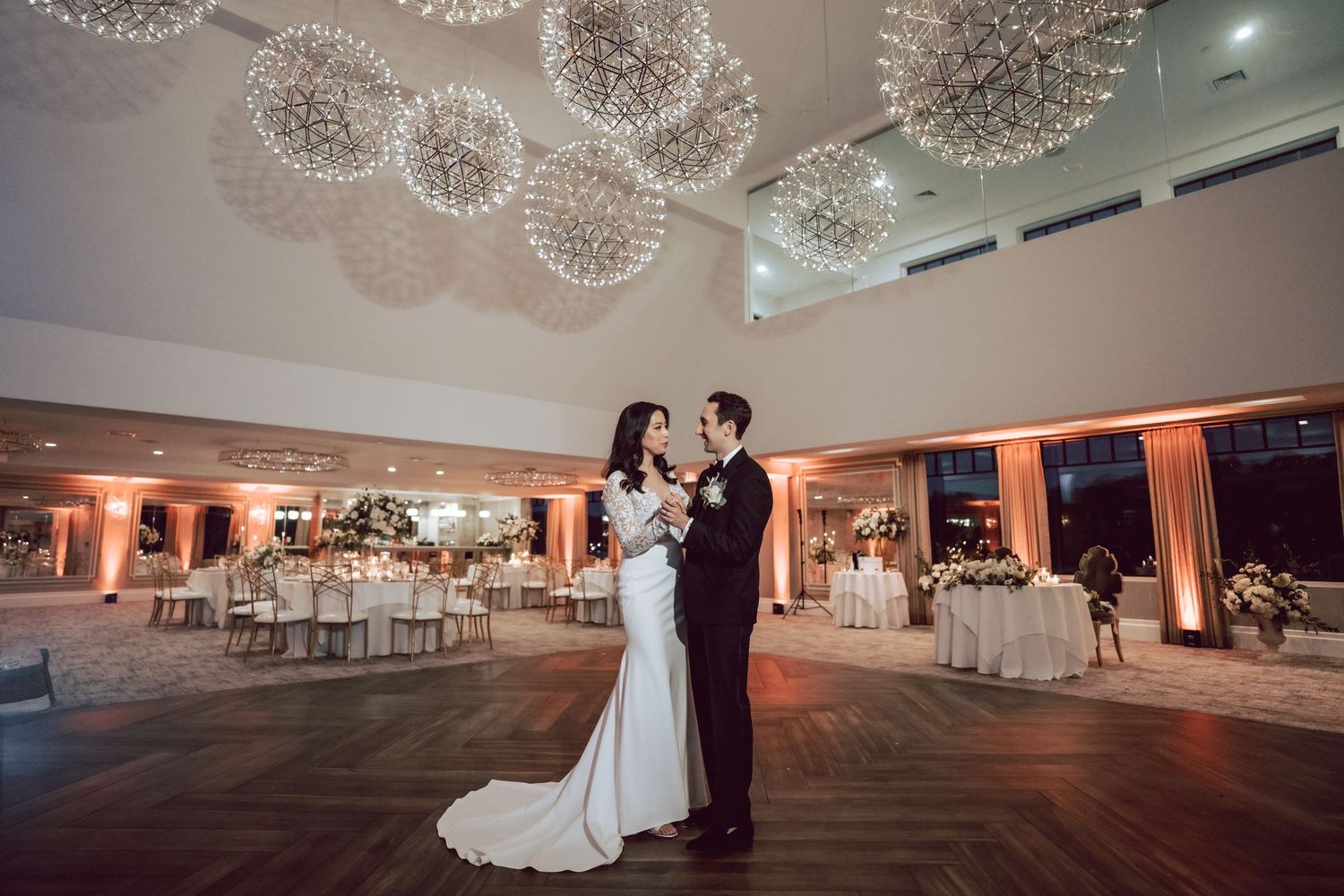 Newlyweds practicing their first dance before their reception hosted at the Water's Edge Caterer