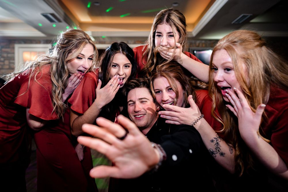 Energetic group of wedding guests celebrating and dancing together.