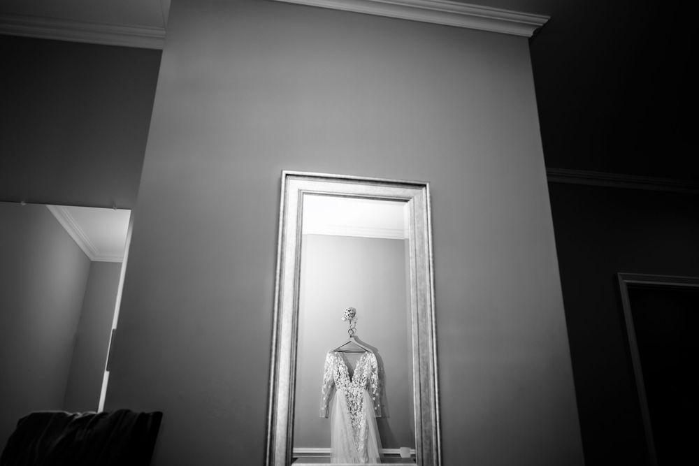 Minimalist black and white hallway interior with dramatic window lighting.