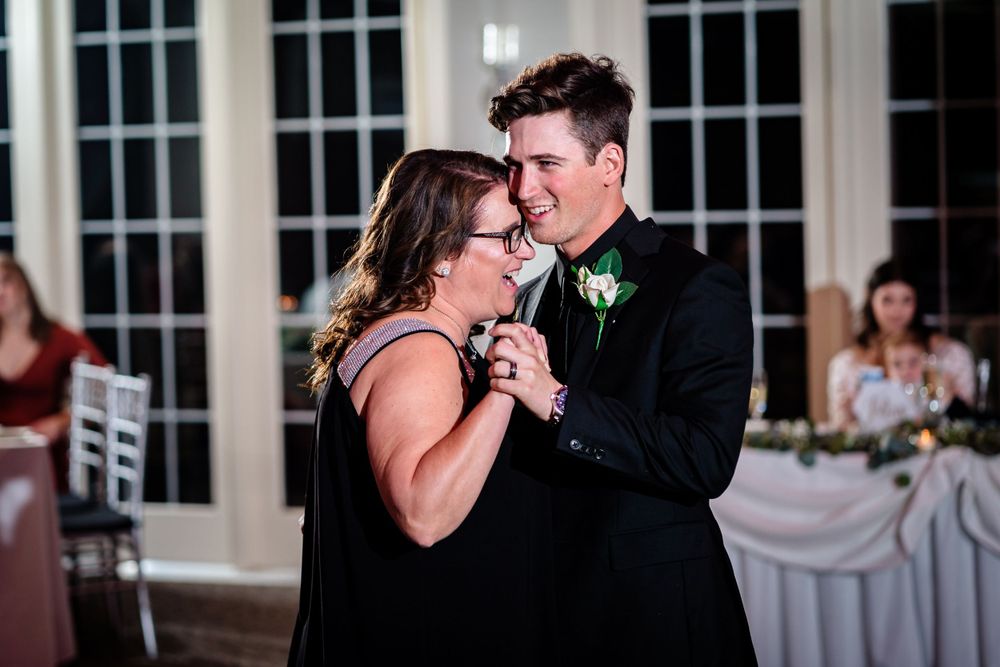 Couple sharing an intimate dance moment at an elegant wedding reception.