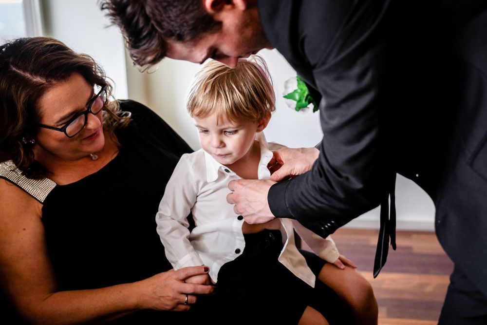 Wedding party members share emotional moments during pre-ceremony preparations.