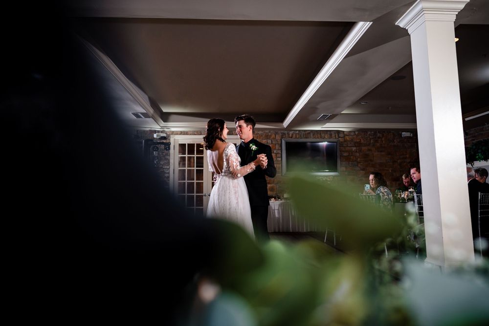 Modern wedding venue interior with white columns and stone accent walls.