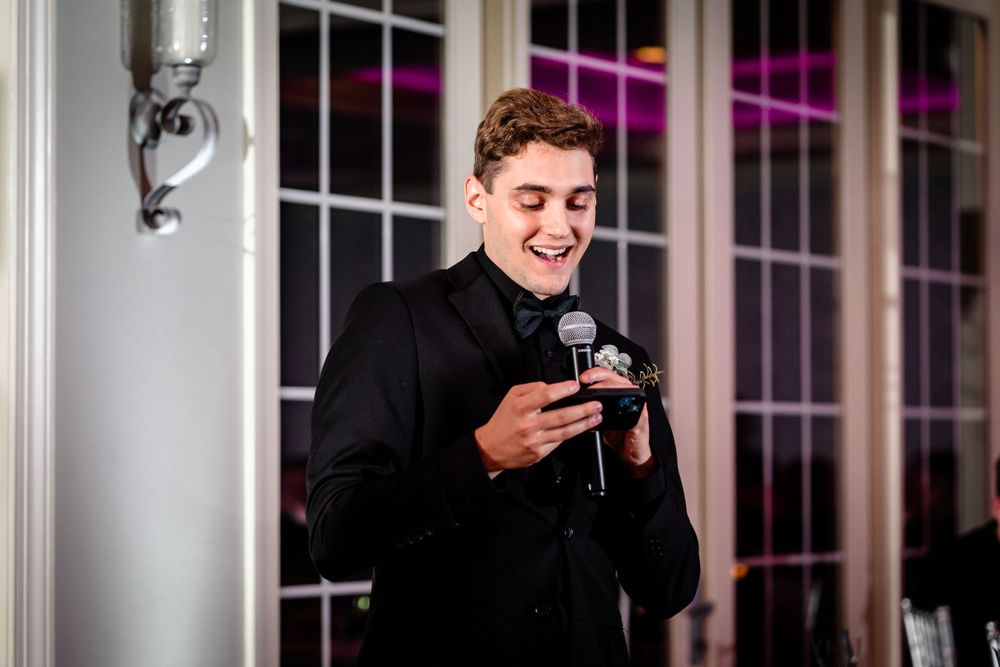 Guests enjoying a lively celebration in a beautifully lit reception venue.