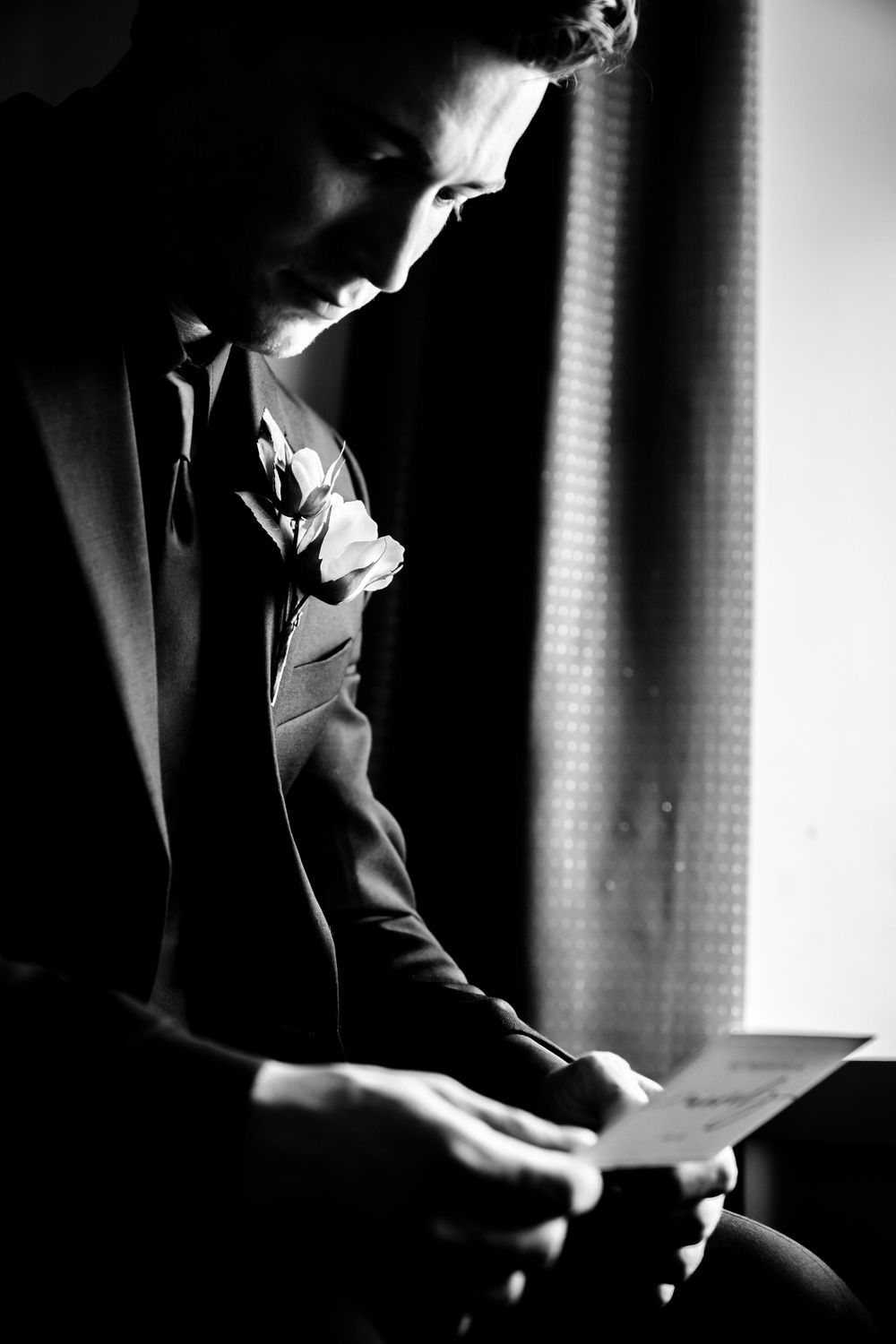Dramatic black and white photos capture preparations before a wedding ceremony.