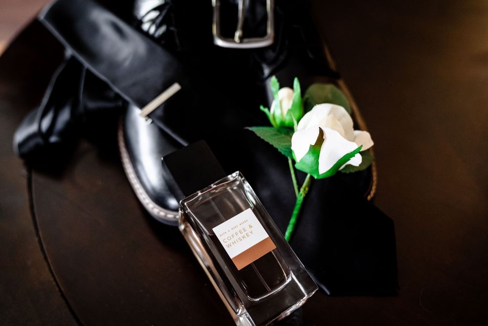 Wedding champagne bottles arranged with dramatic lighting and green accents.