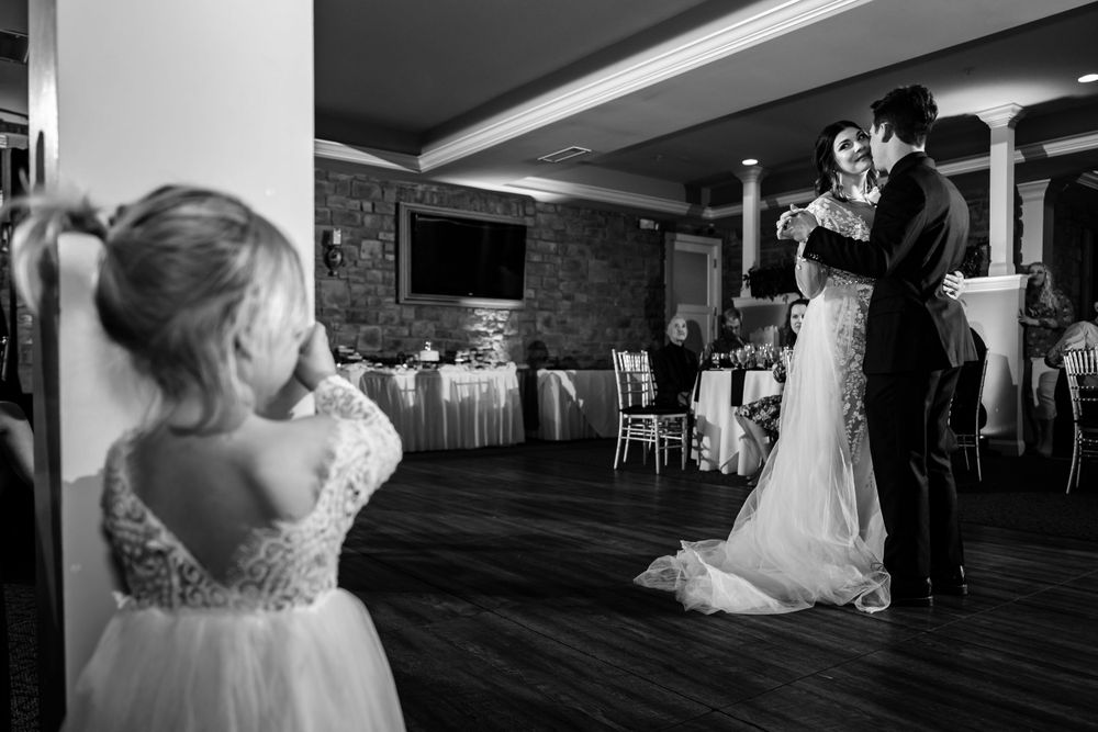 Wedding reception dance floor with elegant white columns and mood lighting.