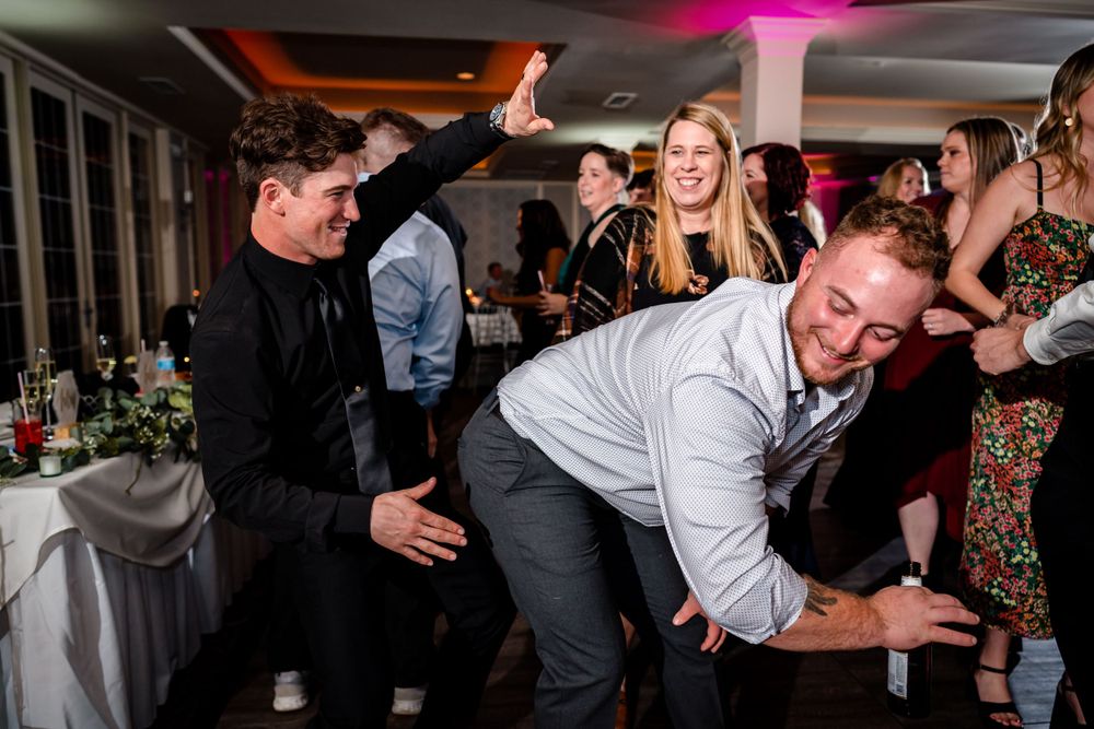 Dynamic dance floor scene with guests celebrating at a wedding reception.