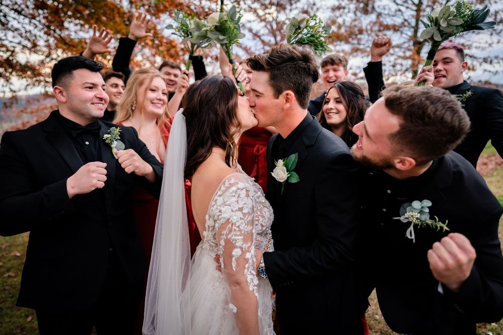 Wedding celebration with guests dancing and enjoying festivities outdoors.
