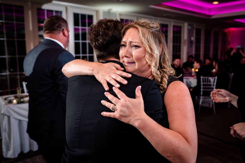 Wedding reception party scene with guests celebrating on the dance floor.