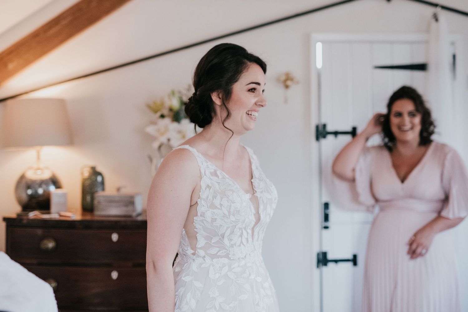 A bright indoor scene capturing a special moment during wedding preparations.