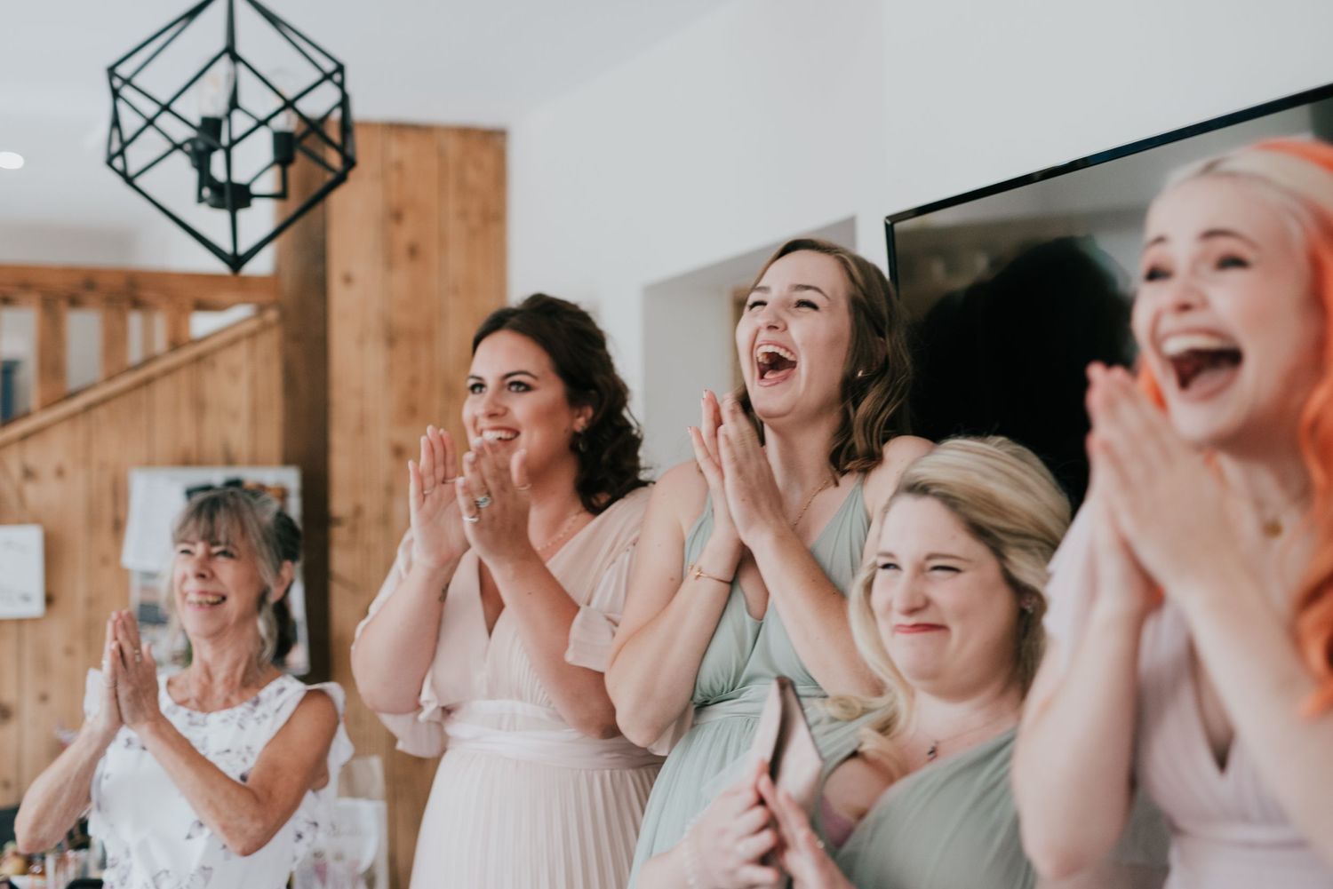 Group reacting with joy and excitement during a wedding celebration.