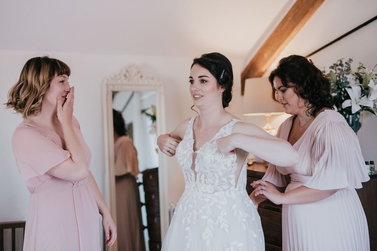 An emotional wedding preparation scene showing reactions to the bride in her white dress.