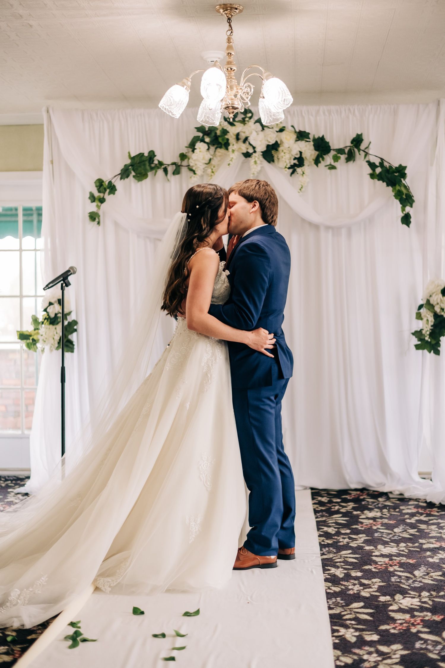 bride and groom share their first kiss at their wedding