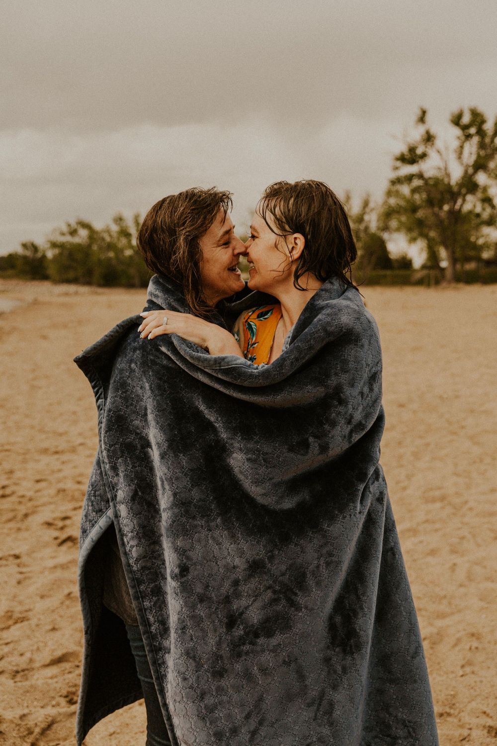 Couples session in South Dakota. Couple shares blanket and dries off from swim.