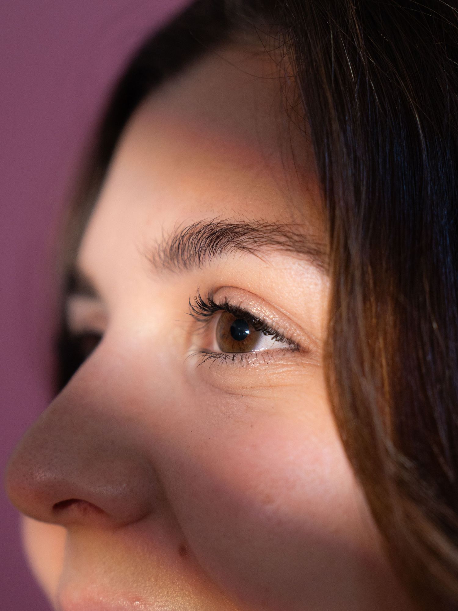 Close-up profile shot showing eye and nose detail with soft lighting.