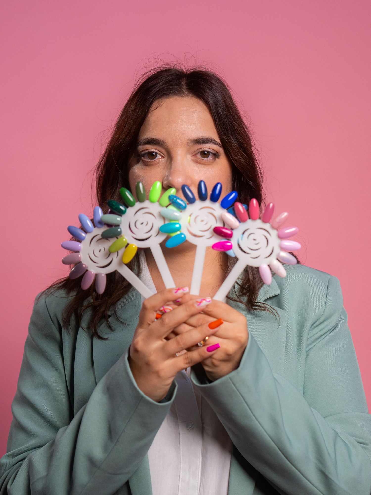 Professional photo series showing hands holding paper finger puppets against a pink background.