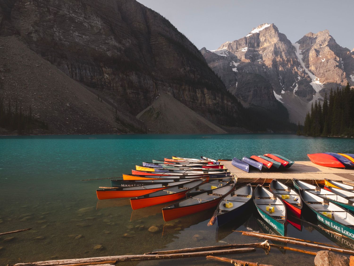 Canoes on Lake Louise in Banff National Park, Alberta Canada with mountains in the background.