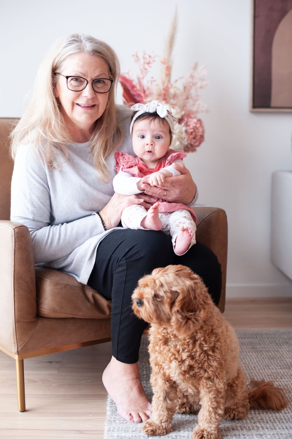 A sweet indoor family moment with a baby and goldendoodle dog sitting together on a brown armchair.
Altona Family Photographer Melbourne