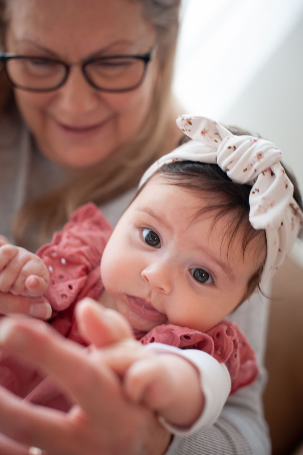 Close-up portrait of a baby wearing a white headband and pink dress.
Altona Family Photographer Melbourne
