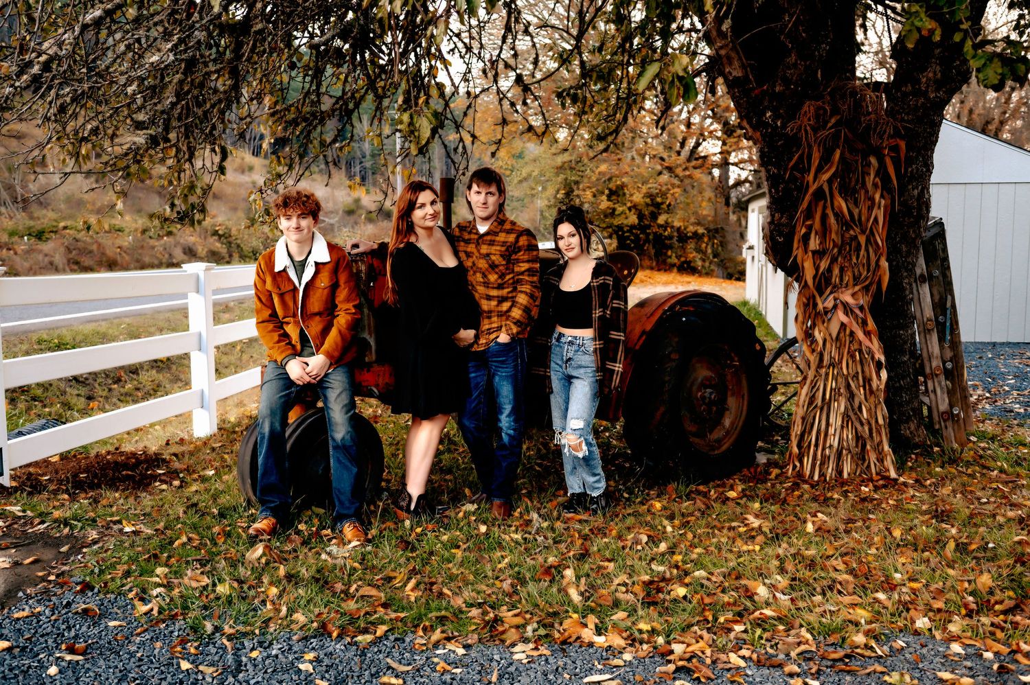 Group portrait against white fence during fall season.
