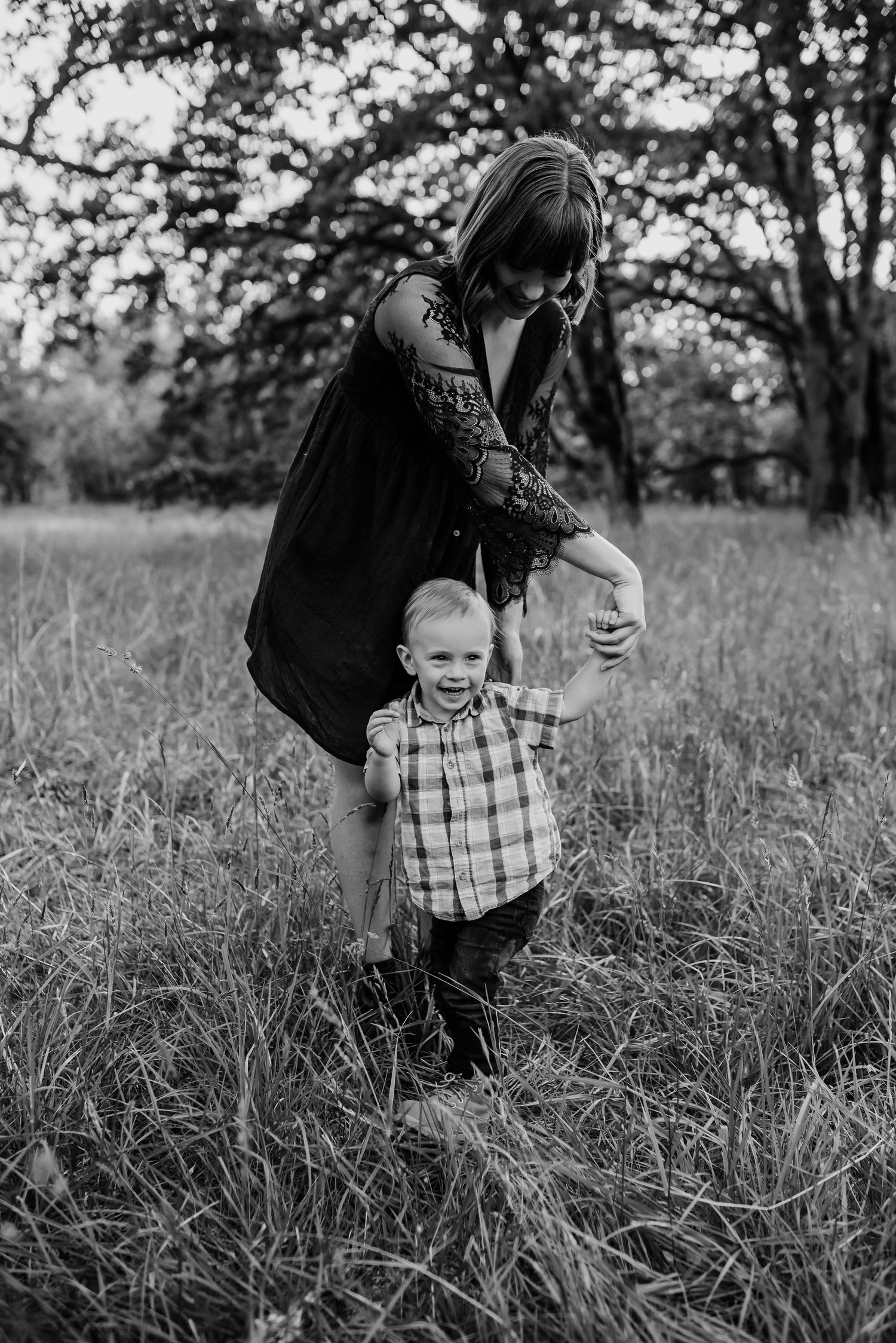 Black and white candid sequence of playful moments in a grassy field.