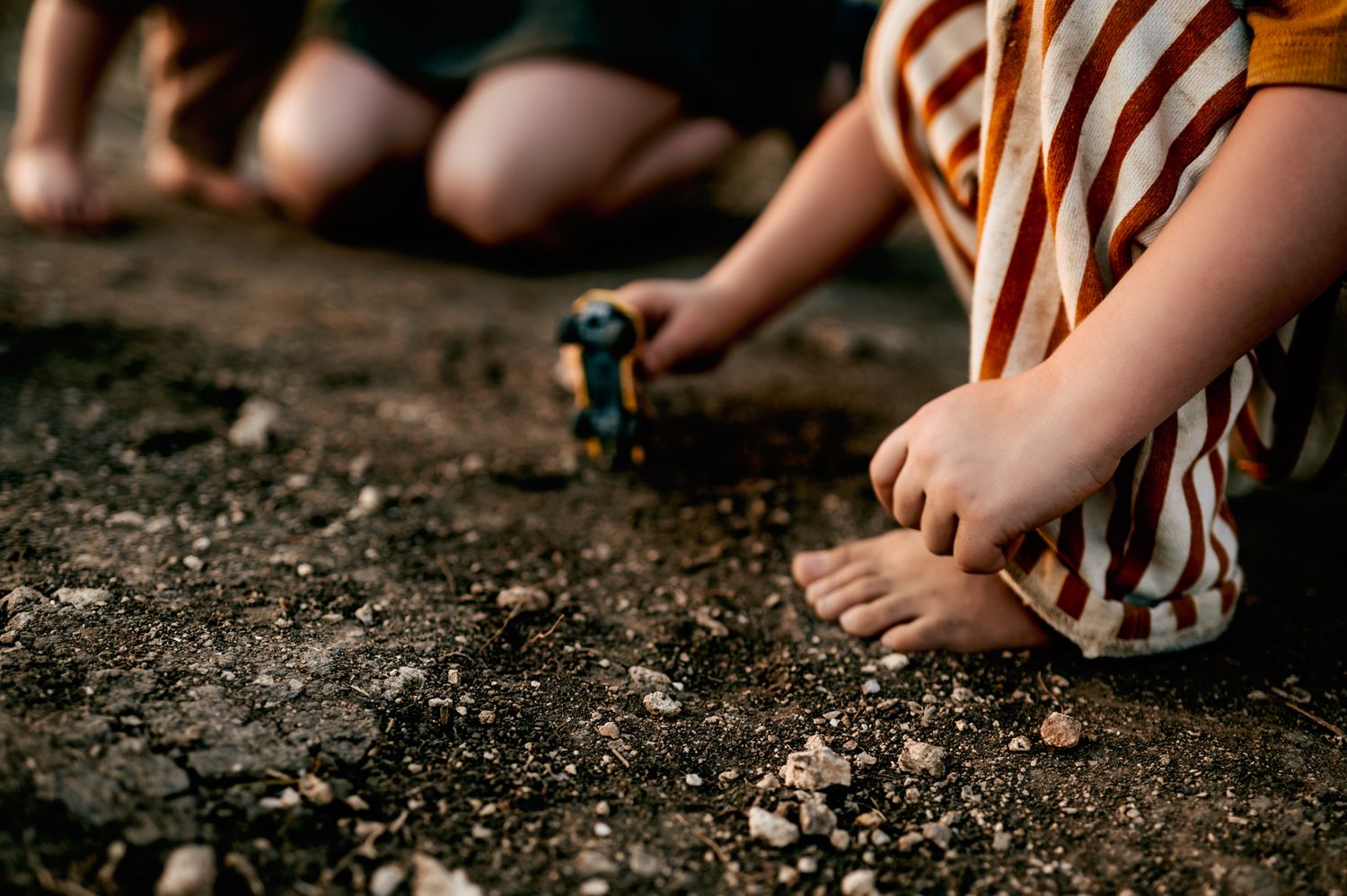 child playing in gravel