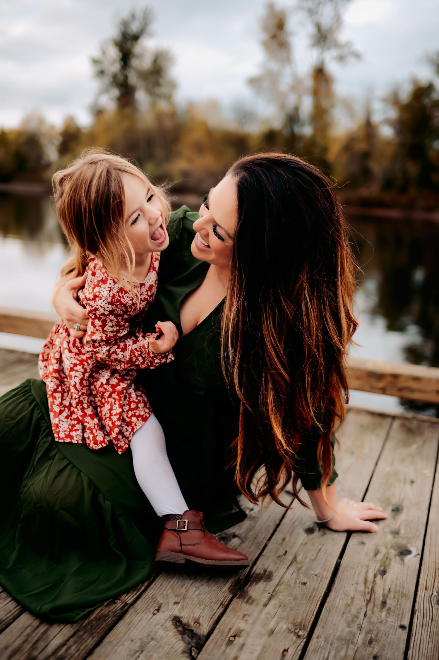 Candid moments shared on a rustic wooden dock during sunset.