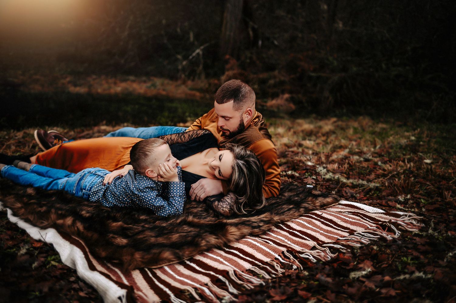 Family laying on blanket