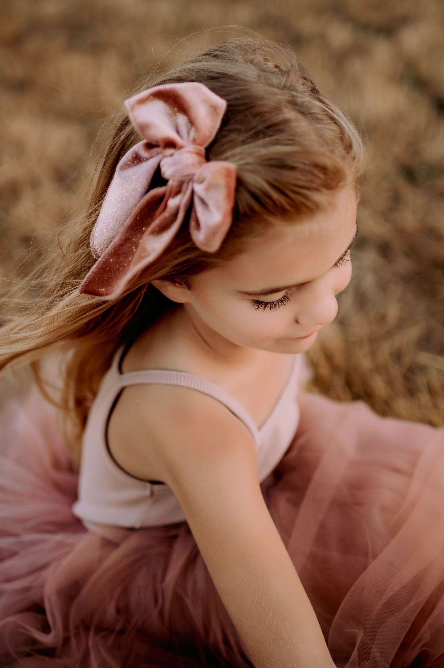Child with pink bow.