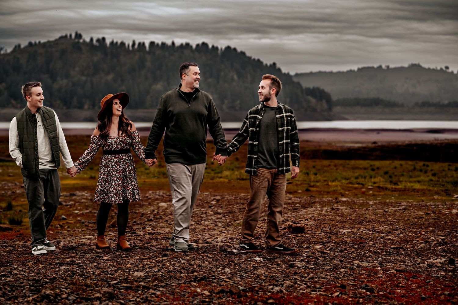 Panoramic view of group posed against moody autumn landscape.