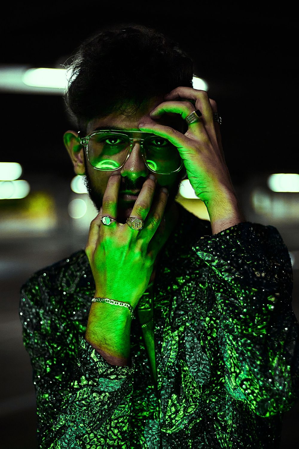 A man illuminated by a green light.
