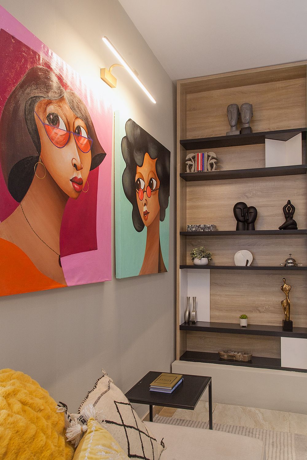 Stylish bedroom featuring colorful pop art portraits on walls with floating wooden shelves.