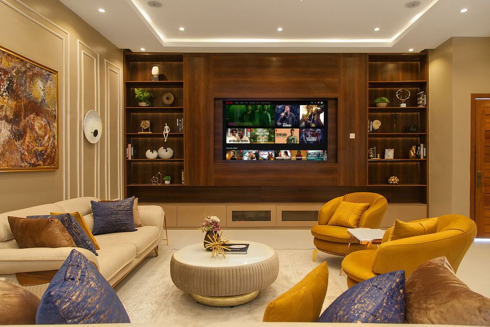 Luxurious living room with built-in entertainment unit and mustard yellow accent furniture.
