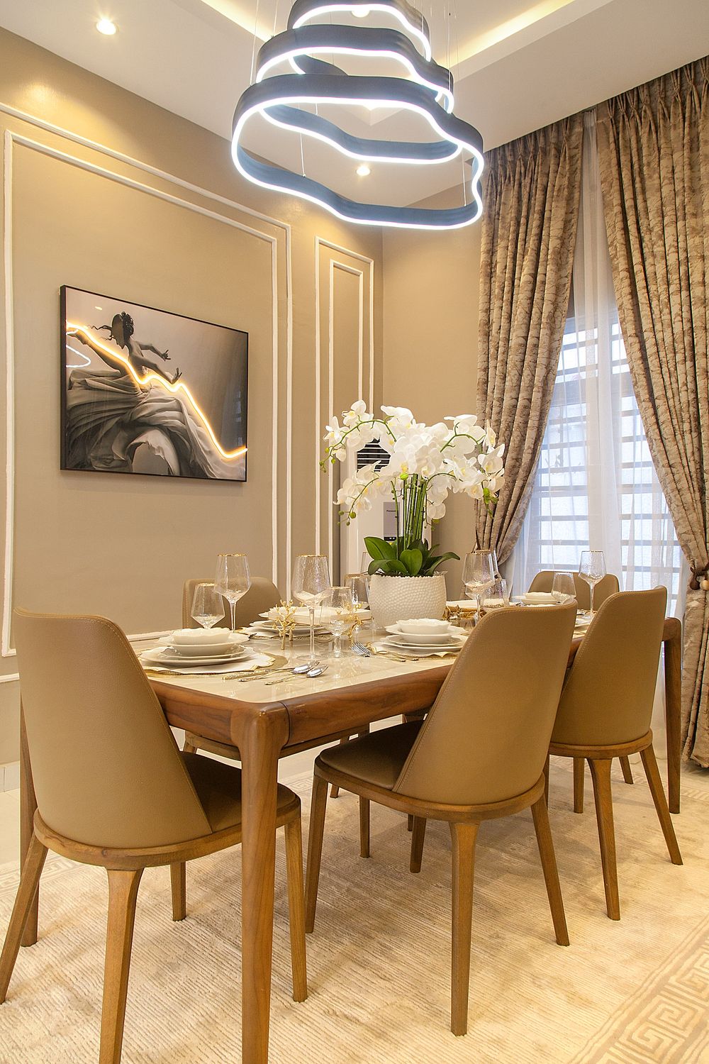 Modern dining room with geometric LED chandelier, beige chairs, and wooden table.